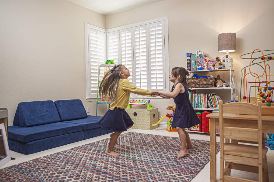Choose Polywood shutters for durable, kid-friendly great room window treatments in Denver. Polywood shutters on multiple windows in a sitting area