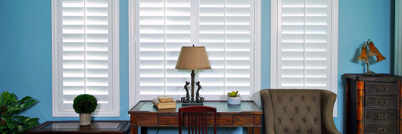 Plantation shutters over a desk