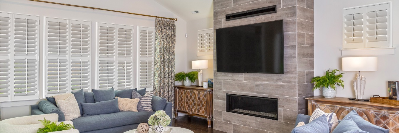 Interior shutters in Highlands Ranch living room with fireplace