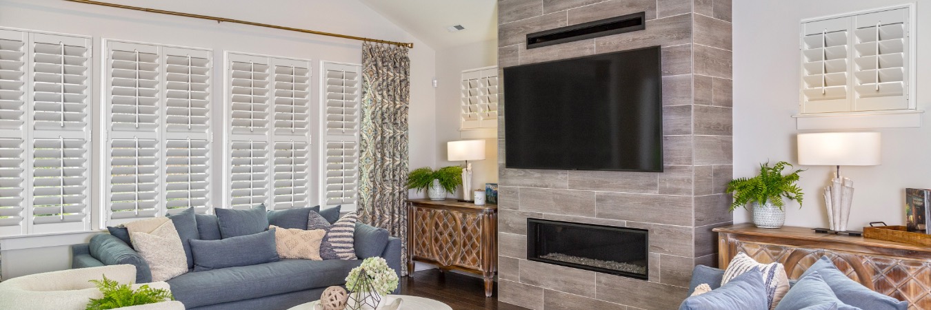 Interior shutters in Thornton living room with fireplace