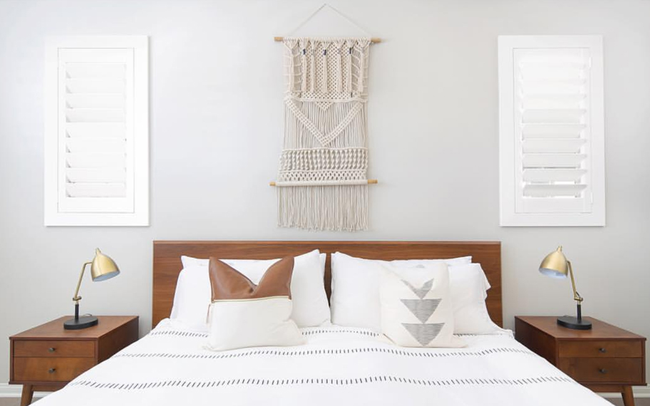 Custom-fitted louvered shutters provide excellent nighttime privacy in Denver. Photo Credit: Audrey Crisp Louvered shutters in a bedroom.