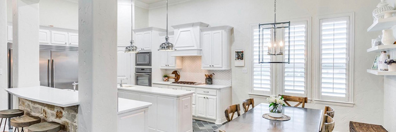 White shutters in a large modern white kitchen