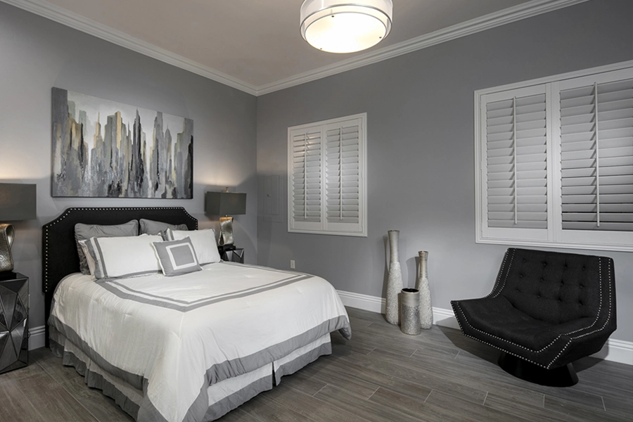 Close your custom Polywood shutters to beat the heat and keep your Denver bedroom cool. White Polywood shutters on bedroom windows