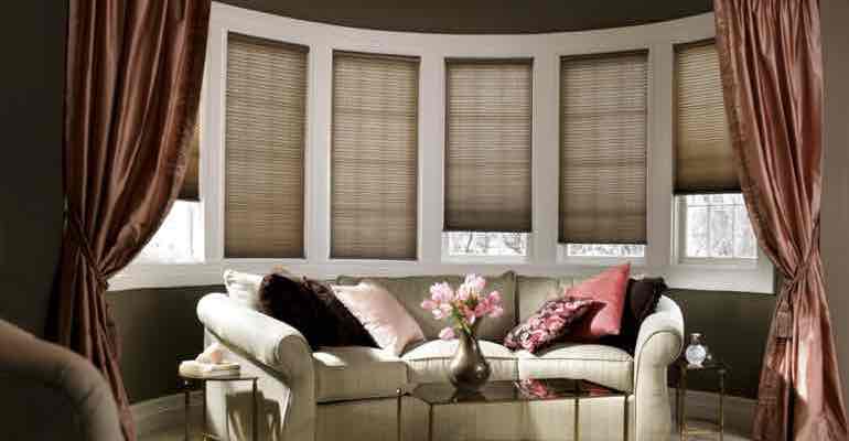 Adjustable cellular shades in parlour bow window.