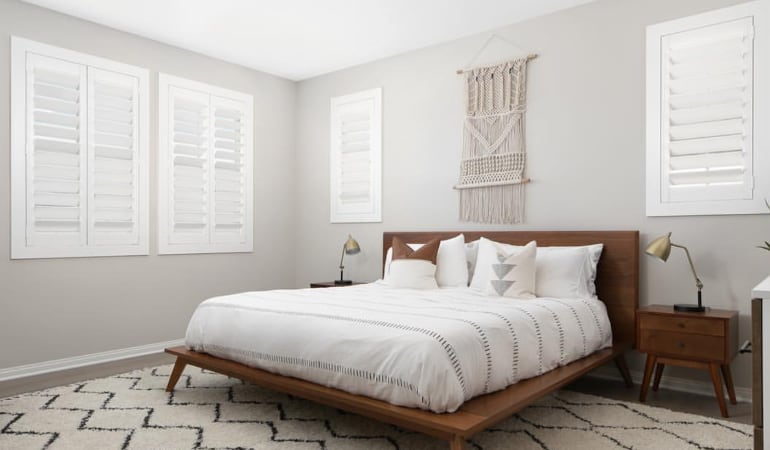 Open shutter louvers will help any Denver room feel larger. Plantation shutters in a model home bedroom.