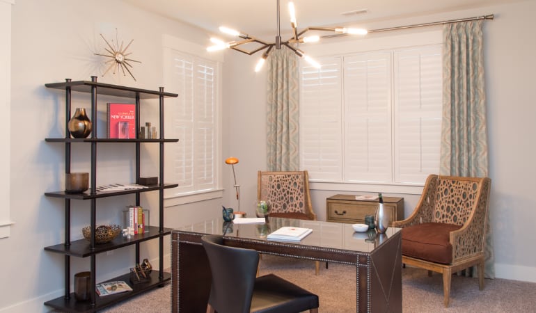 Picking the right window treatments can result in an increase in natural light. Denver home office with plantation shutters.