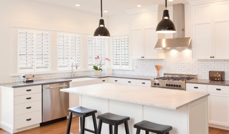 Plantation shutters let you control the amount of light in your kitchen. Plantation shutters in a bright Denver kitchen.