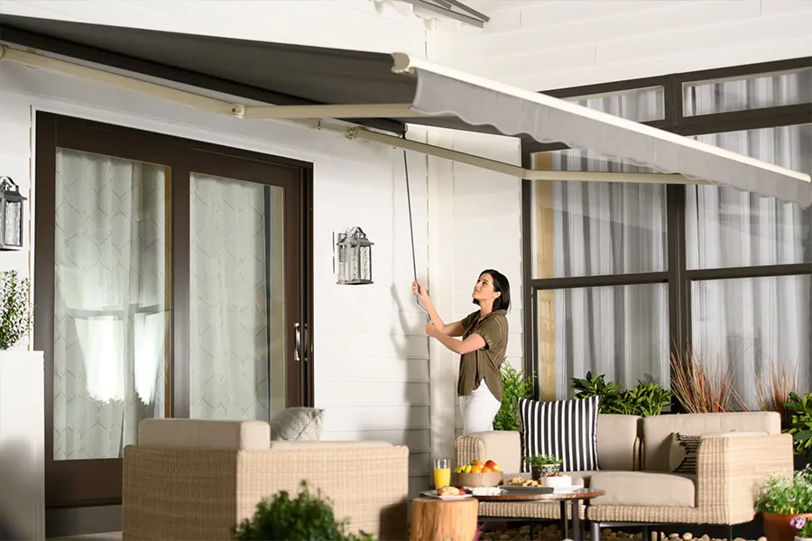  A woman operating a manual awning