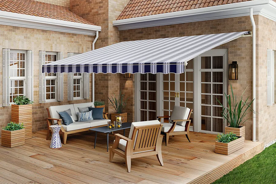 A white and navy blue striped awning shading a wood deck