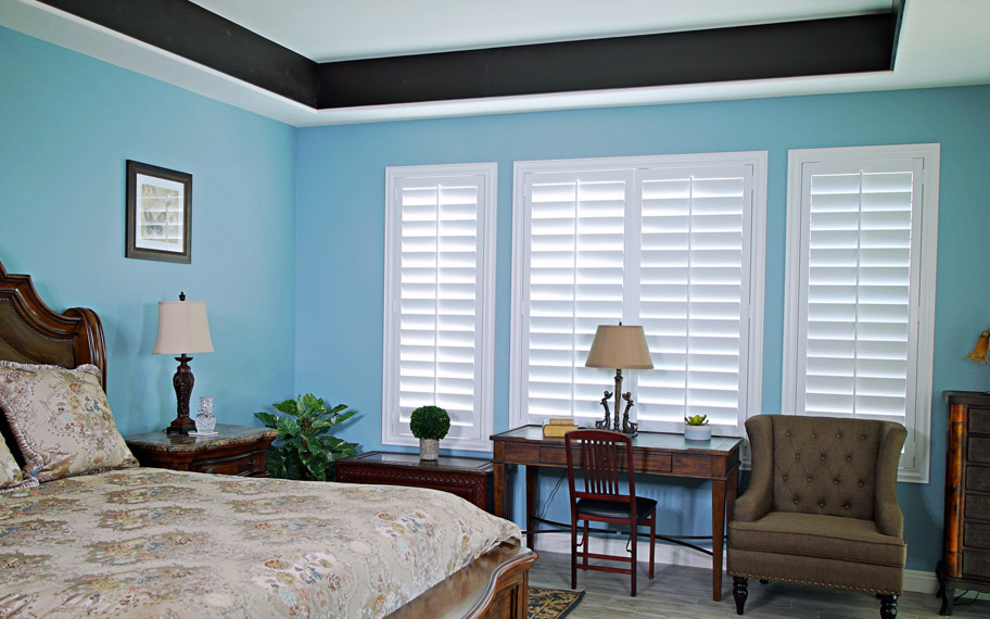 Polywood shutters provide insulation for the perfect temperature all year long in Denver. Polywood shutters in a bedroom.