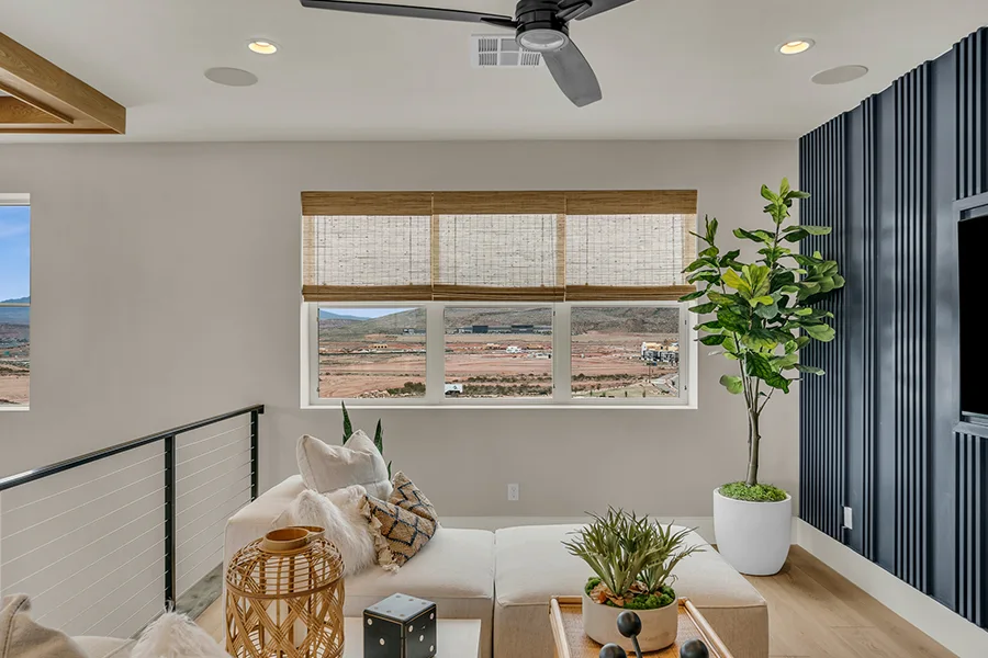 Denver homeowners who want eco-friendly home fixtures should consider natural woven shades. Natural brown woven shades on a window in a stylish sitting area