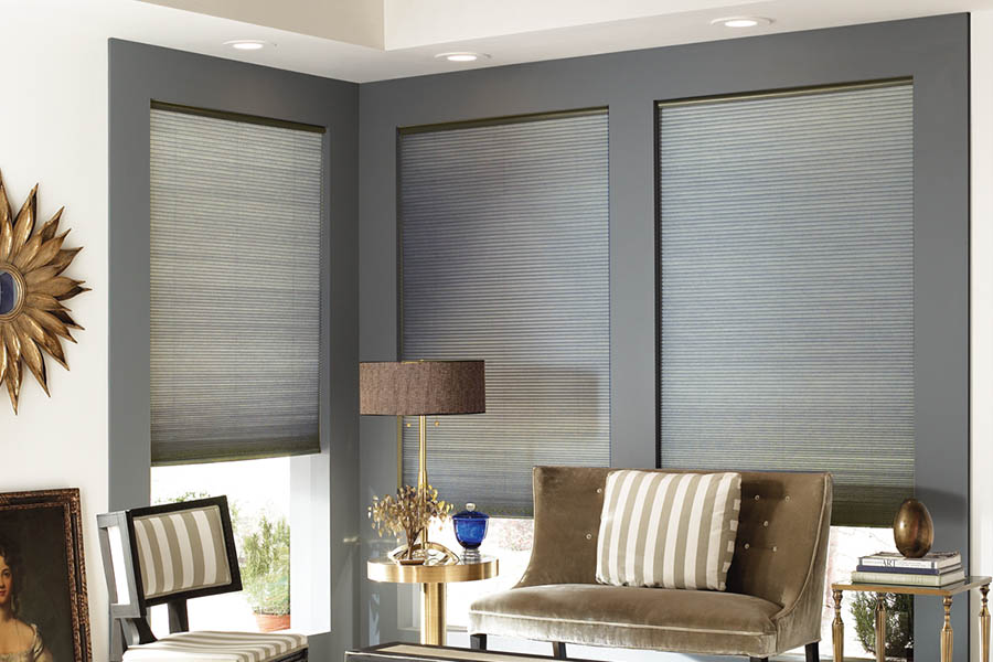 Add style and comfort to your home with cellular shades in Denver. Gray cellular shades in a corner of a stylish living room.