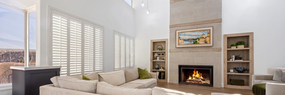 white polywood shutters in several windows within a living room