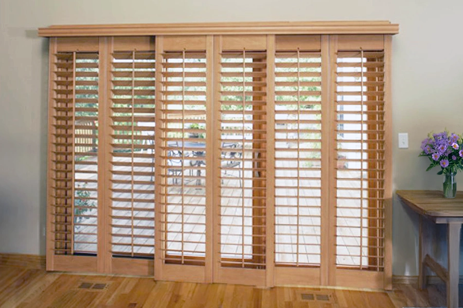 Natural wood plantation shutters are a stunning, fully functional solution for sliding glass doors. Wood shutters installed on a panel track over a sliding glass door