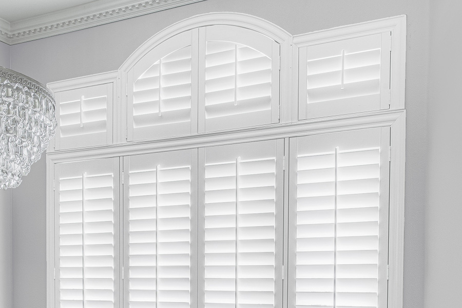 Customize your Palladian windows with white Polywood shutters in Denver. White Polywood Palladian windows in a dining room.