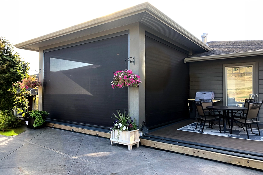 A home deck with a roof and exterior screens over half of it