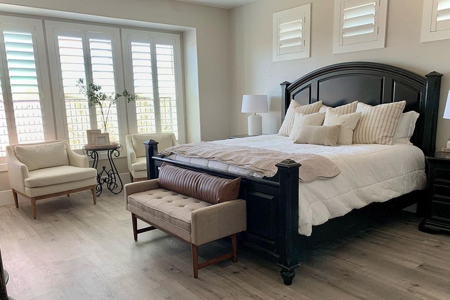 Feeling warm? Block hot UV rays with energy-efficient Polywood shutters in your Denver home. Photo credit: At Home With Devanie Stylish bedroom with elegant furniture and large windows covered by Polywood plantation shutters.